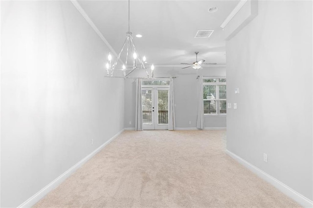 spare room with french doors, ceiling fan with notable chandelier, and carpet floors