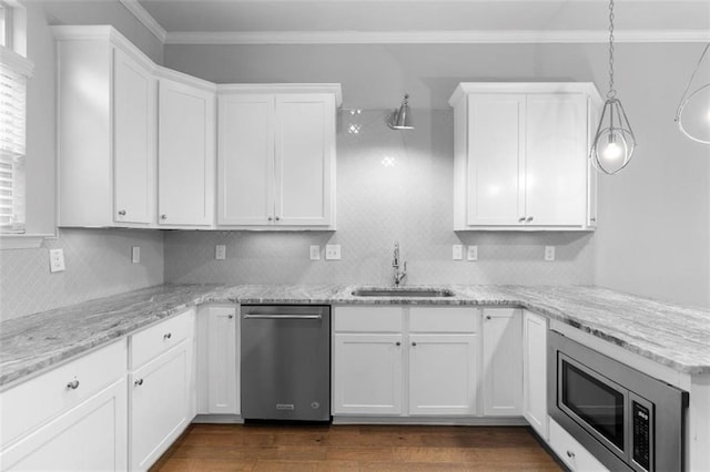 kitchen with pendant lighting, sink, white cabinets, and appliances with stainless steel finishes