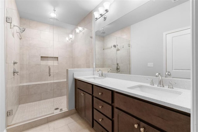 bathroom featuring tile patterned flooring, vanity, and an enclosed shower