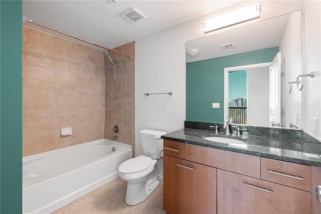 full bathroom with tile patterned flooring, vanity, toilet, and tiled shower / bath