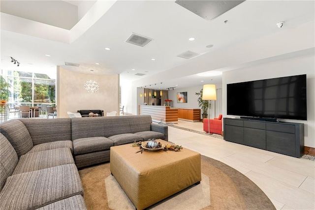 living room featuring a chandelier and light tile patterned floors