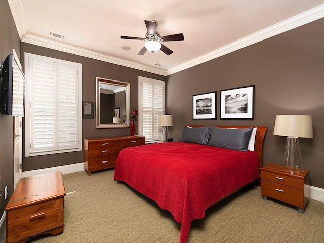 carpeted bedroom with baseboards, visible vents, ceiling fan, and ornamental molding