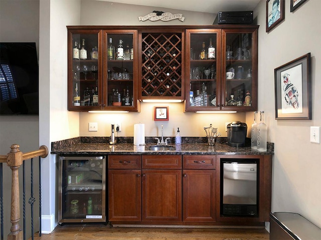 bar featuring wet bar, beverage cooler, refrigerator, and a sink