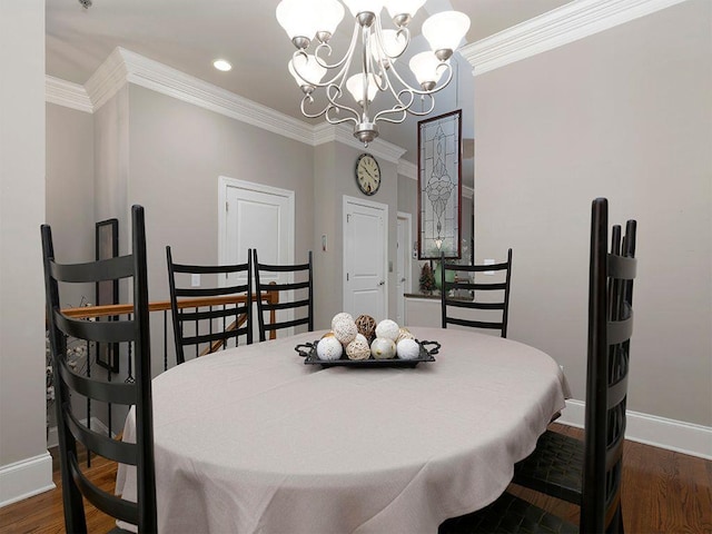 dining room with ornamental molding, baseboards, an inviting chandelier, and wood finished floors