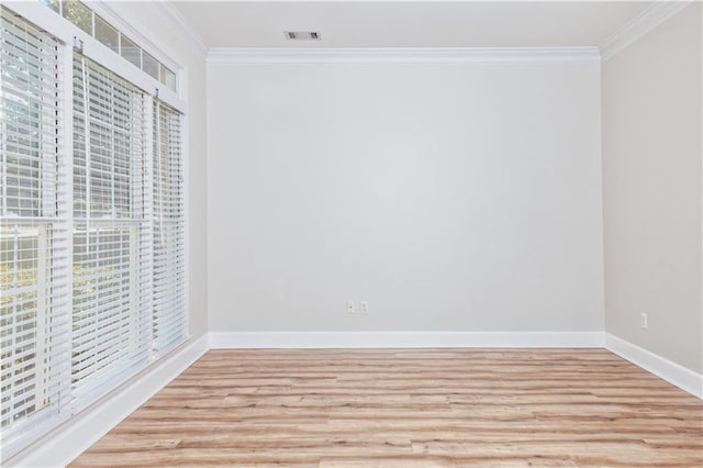 unfurnished bedroom with crown molding, baseboards, light wood-type flooring, and multiple windows