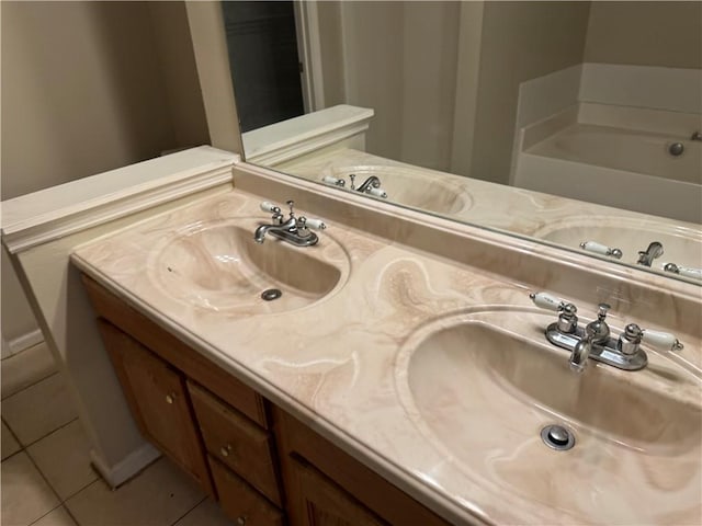 bathroom featuring double vanity, a sink, and tile patterned floors