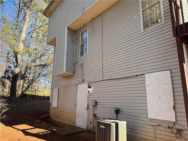 view of side of home with central air condition unit