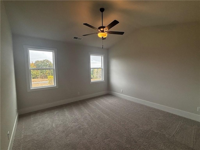 unfurnished room with carpet flooring, a wealth of natural light, and lofted ceiling