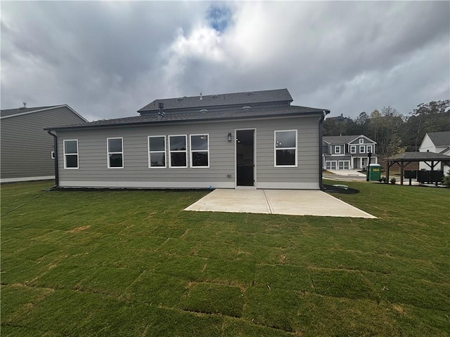 rear view of property with a patio and a yard