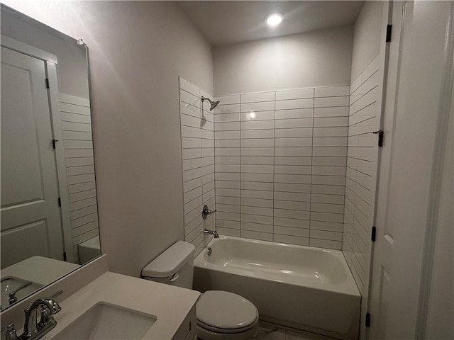 full bathroom with toilet, vanity, and tiled shower / bath