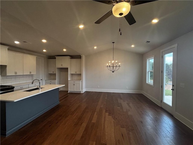 kitchen featuring white cabinets, dark hardwood / wood-style flooring, lofted ceiling, and sink