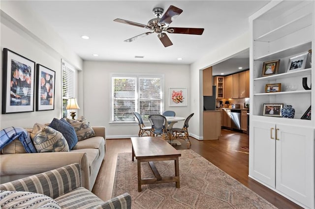 living room with dark wood-type flooring, recessed lighting, a ceiling fan, and baseboards