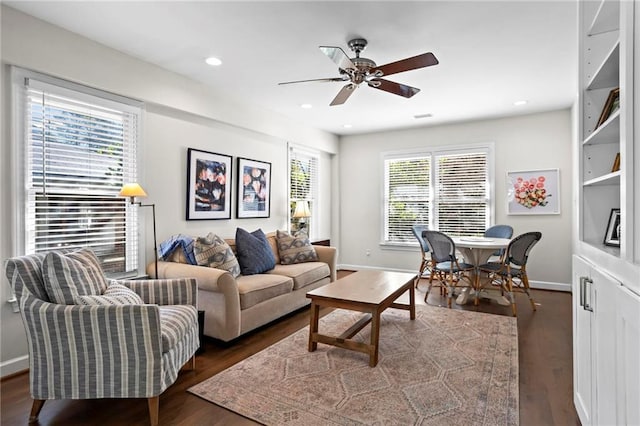 living area with dark wood-style floors, recessed lighting, and baseboards