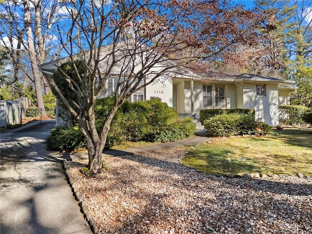 view of front facade with fence and stucco siding