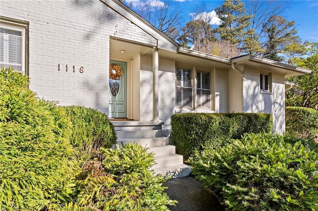 property entrance with brick siding