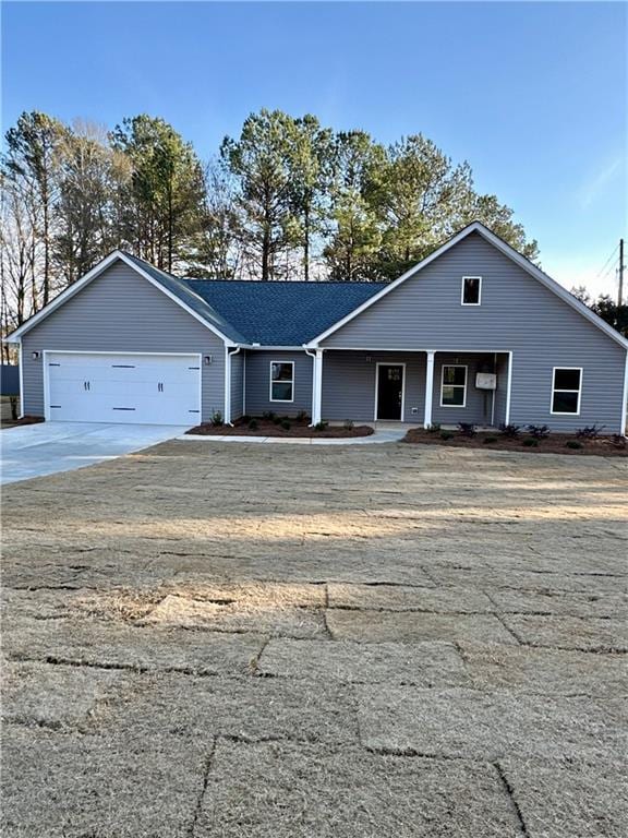 view of front of house with a garage and concrete driveway