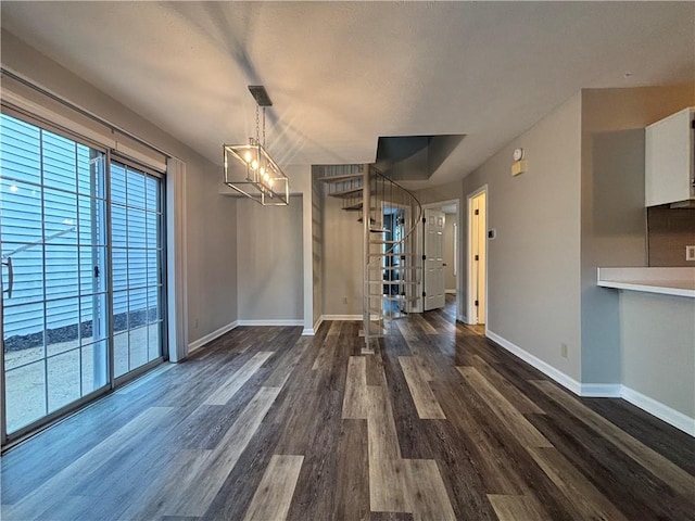 1822 Commonwealth Dr, Woodstock, GA 30188 - unfurnished dining area featuring dark wood finished floors, baseboards, and a chandelier