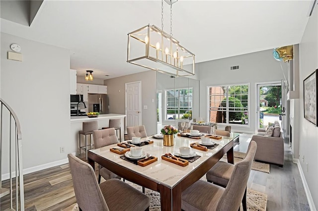 1822 Commonwealth Dr, Woodstock, GA 30188 - dining space with light wood-style flooring and baseboards