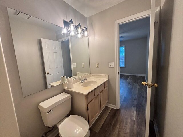 1822 Commonwealth Dr, Woodstock, GA 30188 - half bathroom with wood finished floors, toilet, vanity, and baseboards