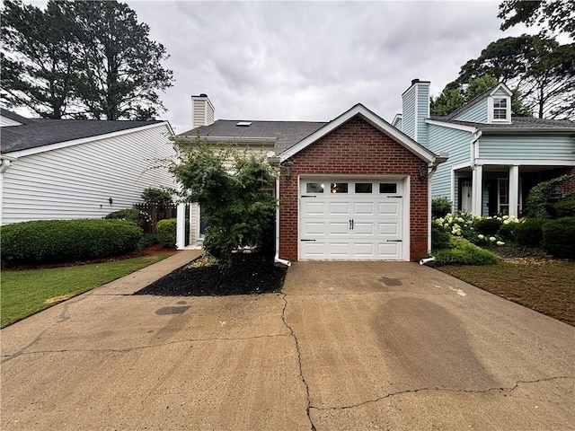 1822 Commonwealth Dr, Woodstock, GA 30188 - view of home's exterior featuring brick siding, a chimney, driveway, and an attached garage
