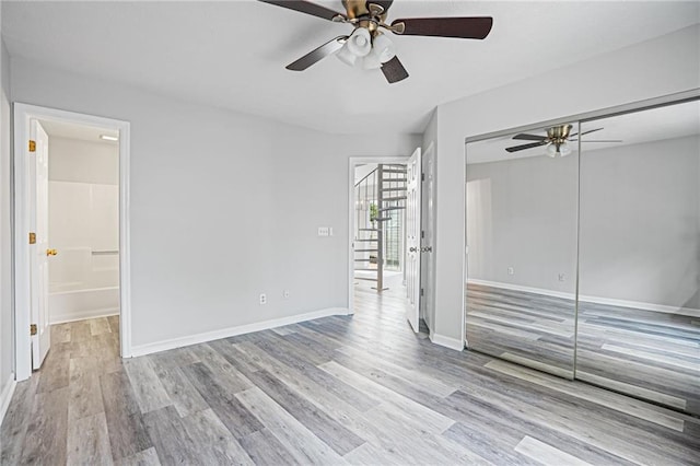 1822 Commonwealth Dr, Woodstock, GA 30188 - unfurnished bedroom with wood finished floors, ensuite bath, a ceiling fan, and a closet