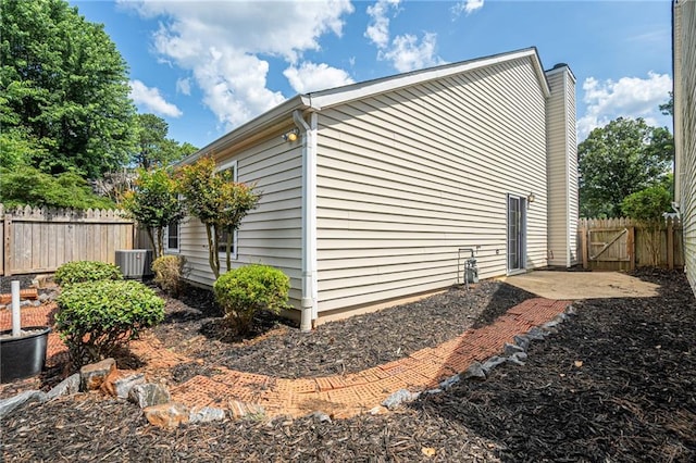 1822 Commonwealth Dr, Woodstock, GA 30188 - view of home's exterior featuring a central AC unit and a chimney