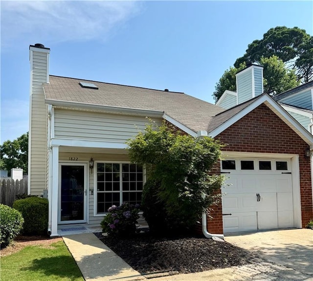 1822 Commonwealth Dr, Woodstock, GA 30188 - view of front facade featuring a chimney, an attached garage, concrete driveway, and brick siding