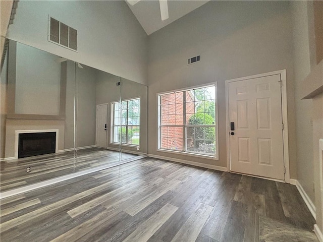 1822 Commonwealth Dr, Woodstock, GA 30188 - unfurnished living room featuring healthy amount of natural light, high vaulted ceiling, wood finished floors, a ceiling fan, and a fireplace