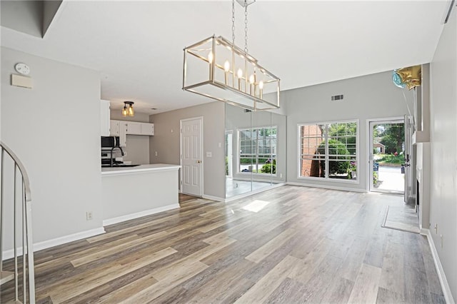 1822 Commonwealth Dr, Woodstock, GA 30188 - unfurnished living room with light wood-style flooring and baseboards