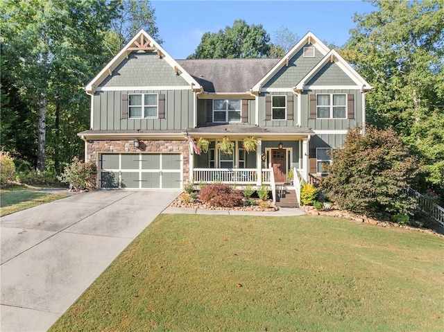 craftsman-style home featuring a front yard, a garage, and a porch