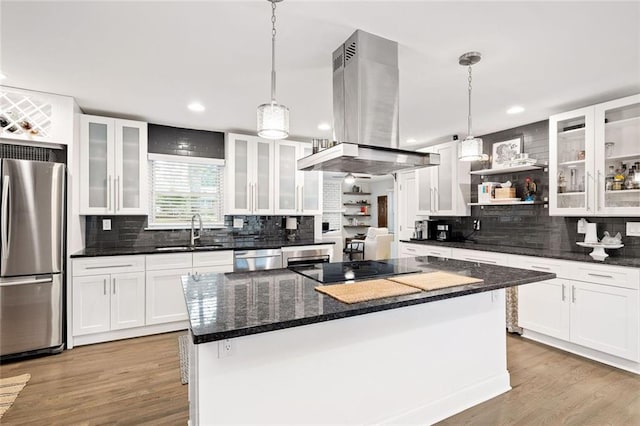 2572 Beverly Hills Dr, Chamblee, GA 30341 - kitchen featuring stainless steel appliances, island exhaust hood, a sink, decorative backsplash, and white cabinetry