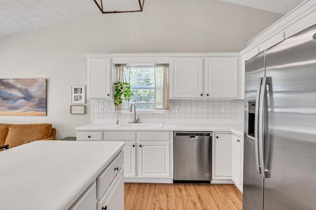 2780 Matlin Way, Buford, GA 30519 - kitchen with stainless steel appliances, a sink, lofted ceiling, backsplash, and white cabinetry