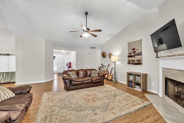 2780 Matlin Way, Buford, GA 30519 - living area featuring lofted ceiling, a ceiling fan, a fireplace, light wood-style floors, and baseboards