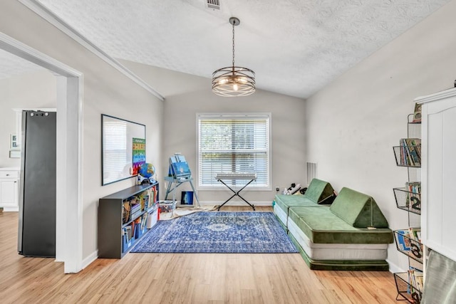 2780 Matlin Way, Buford, GA 30519 - living area featuring vaulted ceiling, light wood finished floors, baseboards, and a textured ceiling