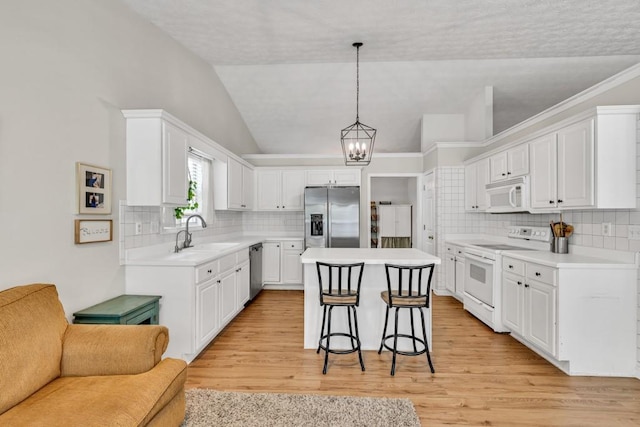 2780 Matlin Way, Buford, GA 30519 - kitchen with stainless steel appliances, open floor plan, a sink, a chandelier, and vaulted ceiling