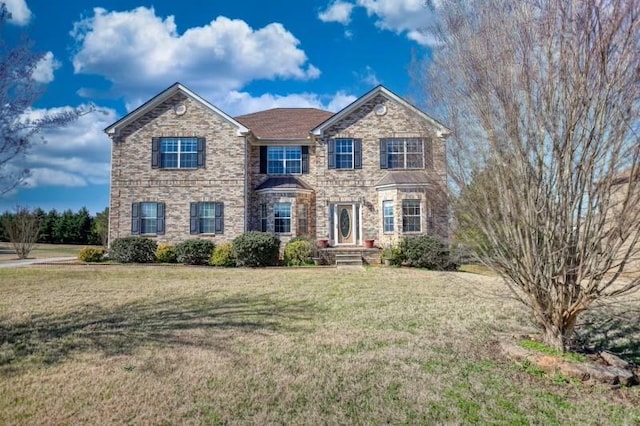 traditional-style home featuring a front lawn