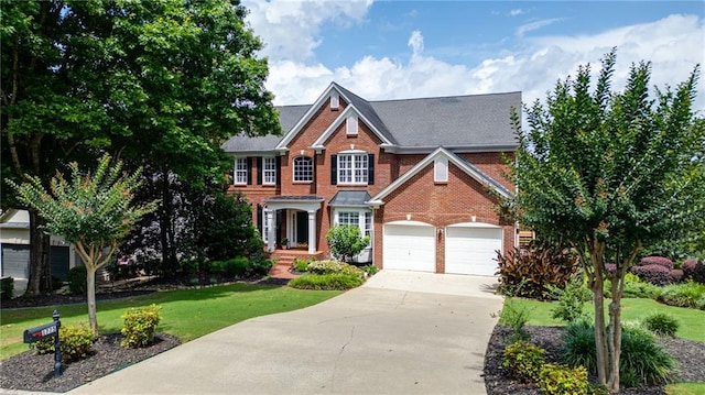 1775 Porterton Way, Cumming, GA 30041 - colonial home featuring brick siding, driveway, a front lawn, and a garage