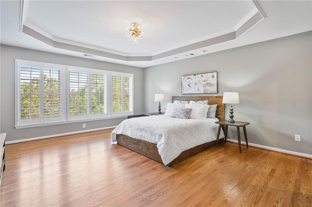 1775 Porterton Way, Cumming, GA 30041 - bedroom featuring a tray ceiling, multiple windows, ornamental molding, and wood finished floors