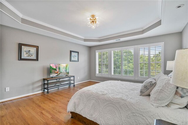 1775 Porterton Way, Cumming, GA 30041 - bedroom featuring a tray ceiling, multiple windows, crown molding, and wood finished floors
