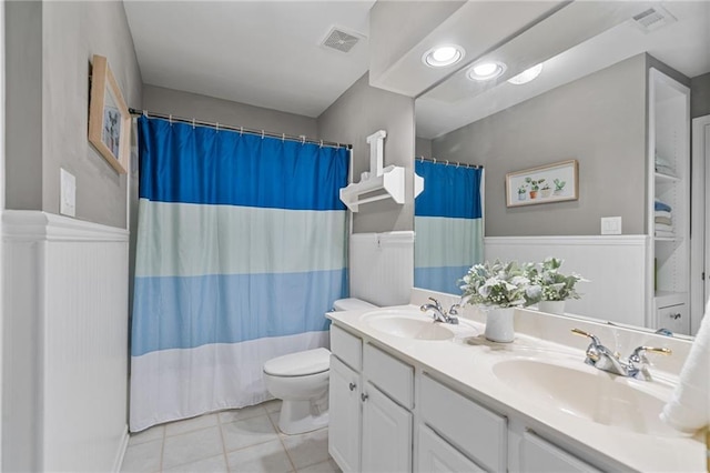 1775 Porterton Way, Cumming, GA 30041 - bathroom featuring double vanity, tile patterned floors, curtained shower, and a wainscoted wall