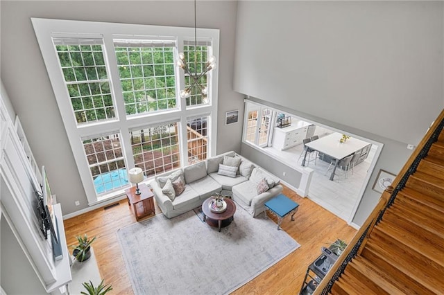 1775 Porterton Way, Cumming, GA 30041 - living room featuring wood finished floors, a high ceiling, and stairs