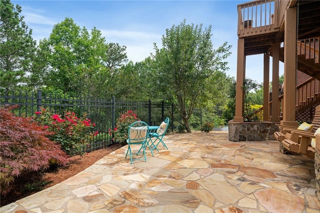 1775 Porterton Way, Cumming, GA 30041 - fenced backyard with stairway, a patio area, and a deck