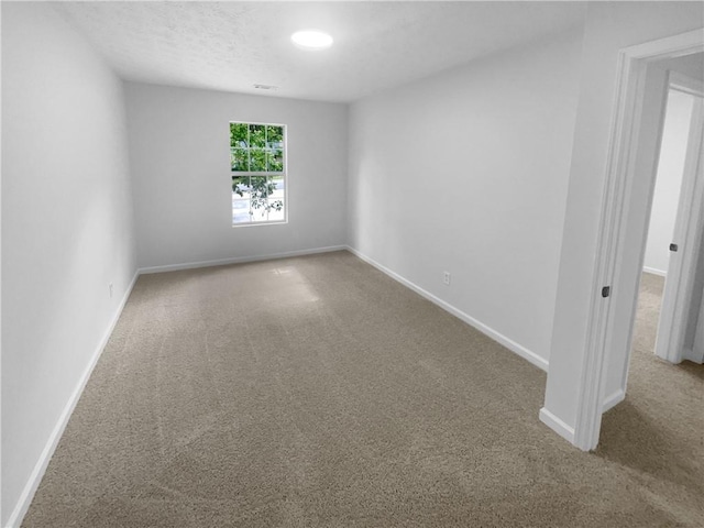 empty room with carpet flooring and baseboards