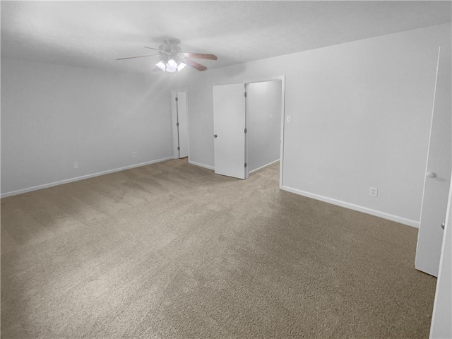 unfurnished bedroom featuring light carpet, baseboards, and a ceiling fan