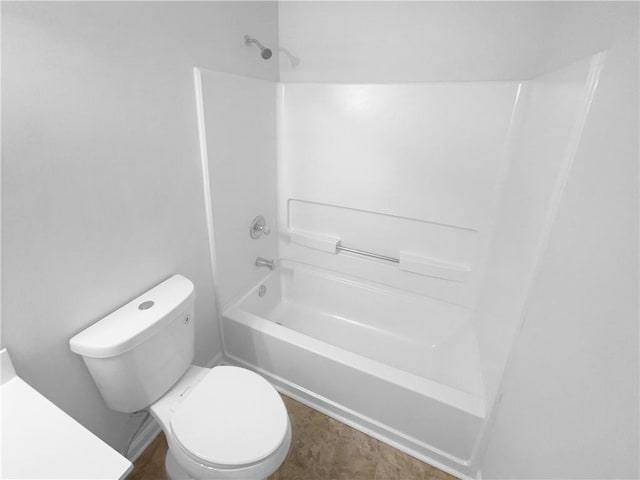 bathroom with toilet and bathtub / shower combination