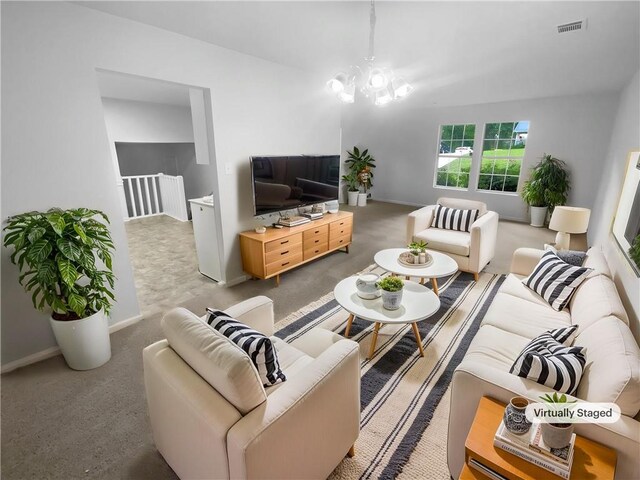 carpeted living area featuring baseboards and a chandelier
