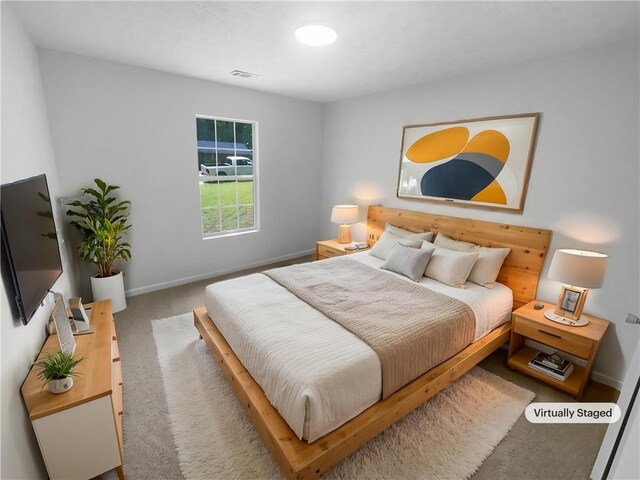 bedroom featuring carpet flooring and baseboards