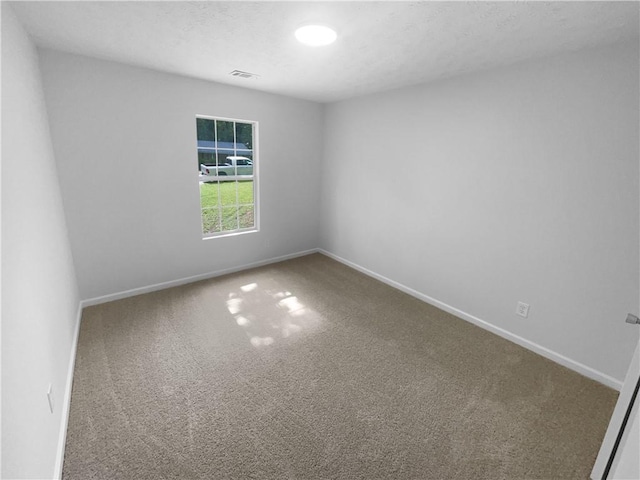carpeted spare room with baseboards