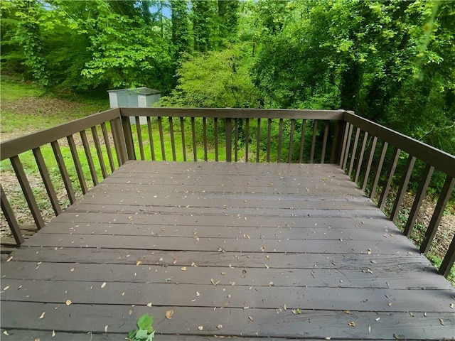 deck with a storage shed and an outbuilding