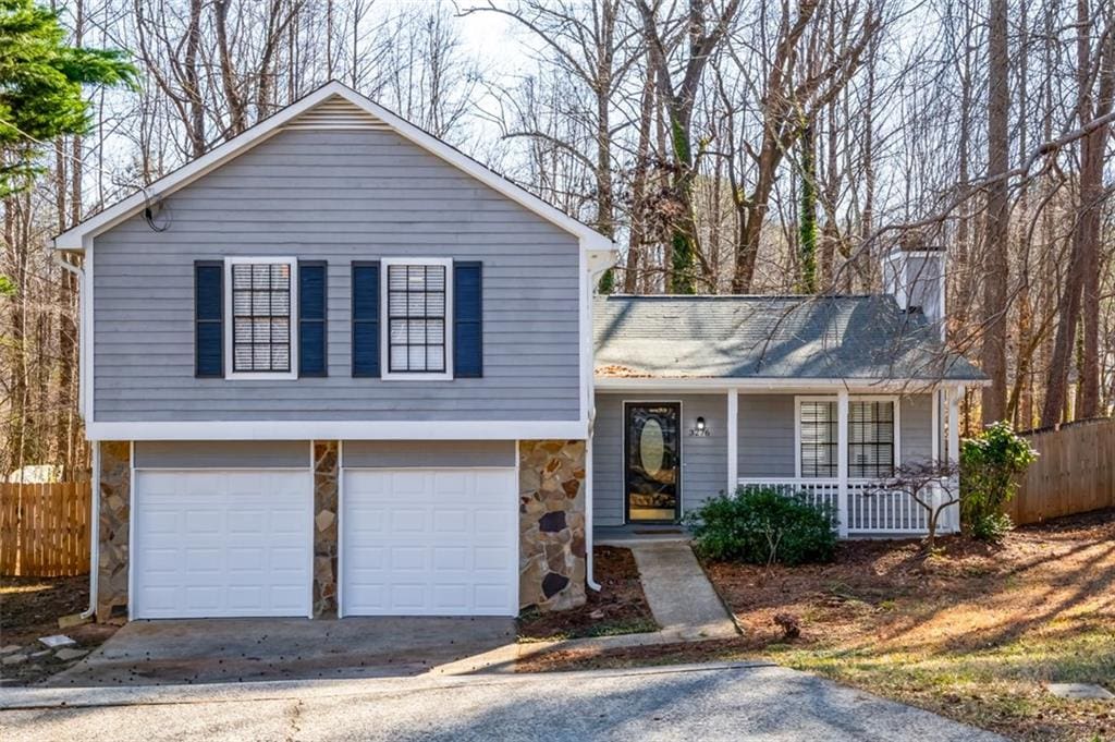 split level home with a garage and covered porch